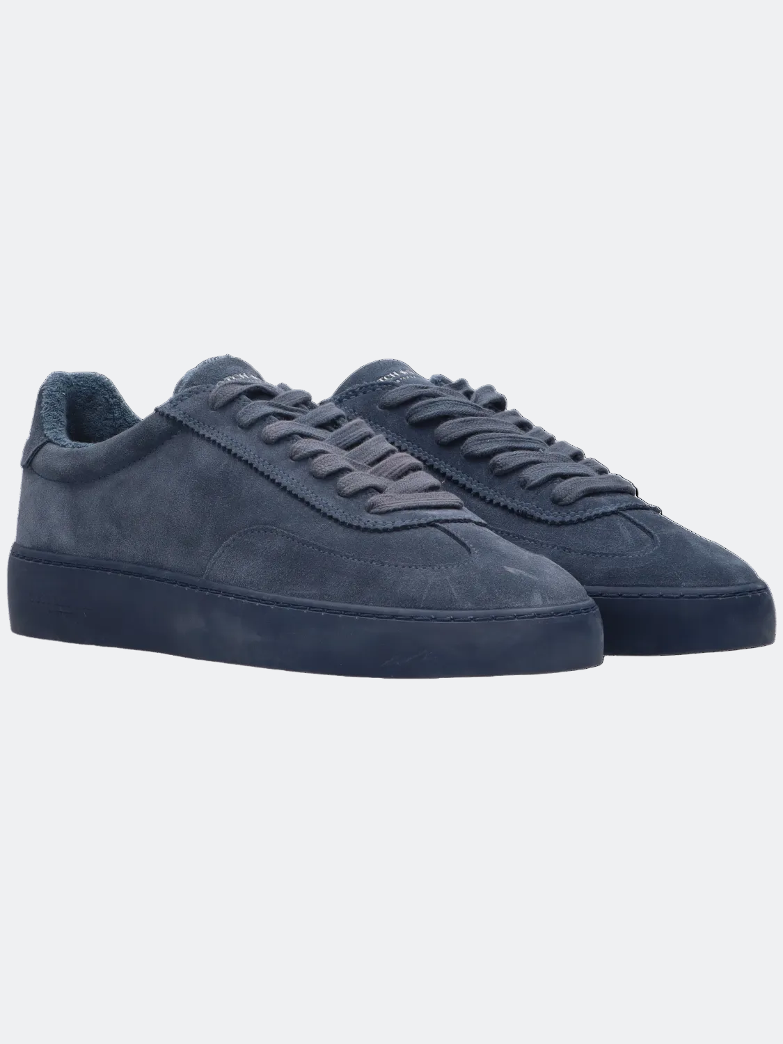 Pair of blue suede sneakers on a white background